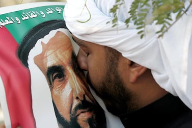 An Emirati man kisses a picture of Sheikh Zayed during his funeral. Rabih Moghrabi / AFP 