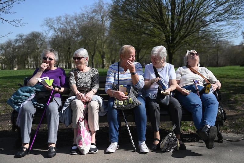 A group of women make the most of the spring sunshine in Regent's Park, London. Under an easing of Covid-19 restrictions, groups of six people can now meet outside in England. EPA