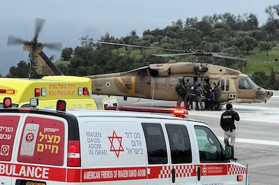 Israeli officials evacuate an injured person after a rocket attack killed one and wounded others in the northern Israeli city of Safed.  Reuters