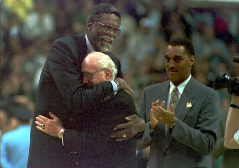 In this 1995 file photo, former Boston Celtic great Bill Russell (L) embraces his old coach and Celtic President Red Auerbach during half time activities commemorating the last regular season game of the Celtics at the Boston Garden. AFP