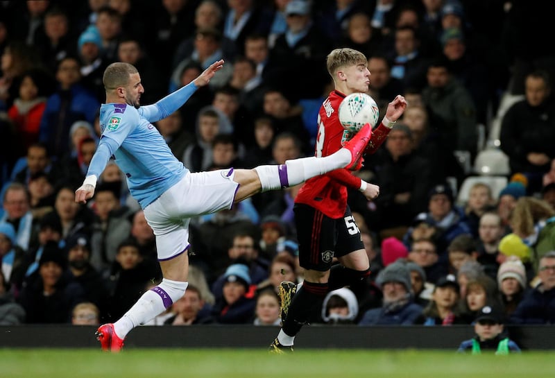 Manchester United's Brandon Williams vies for the ball with Manchester City's Kyle Walker in the League Cup semi-final second leg. Reuters
