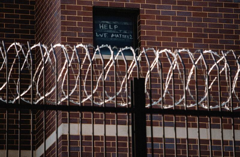 Signs made by prisoners pleading for help are seen on a window of Cook County Jail in Chicago, Illinois, US. Reuters