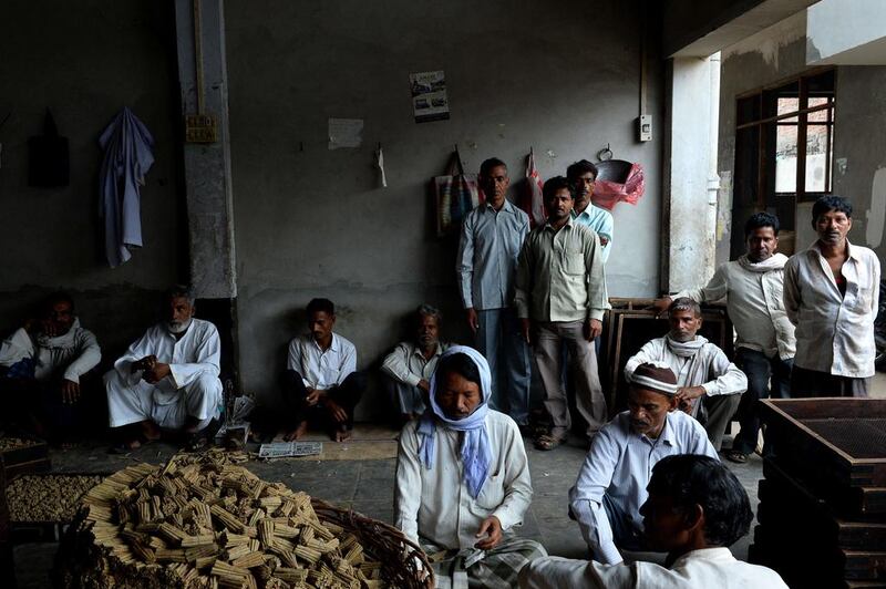Labourers work at The New Sarkar Bidi Factory in Kannauj.