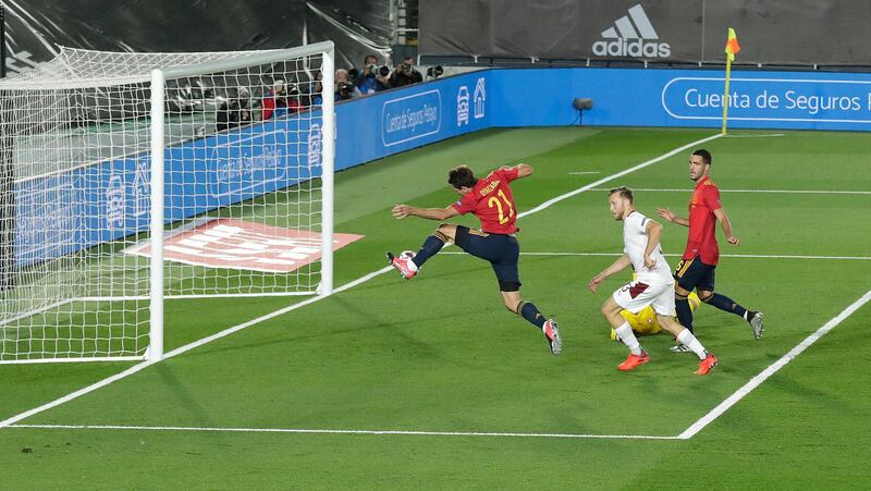 Spain's Mikel Oyarzaba shoots but fails to score with the ball hitting the post. AP