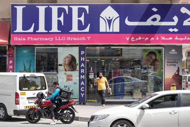 SHARJAH, UNITED ARAB EMIRATES. 04 APRIL 2020. COVID-19 Coverage. General image for gallery and related article. A man leaves a pharmacy in Sharjah. (Photo: Antonie Robertson/The National) Journalist: Standalone. Section: National.