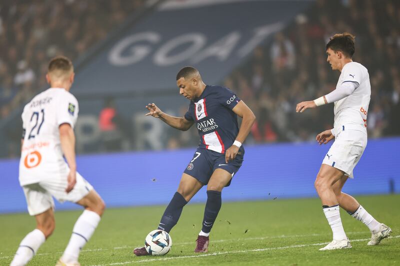 Paris Saint-Germain's Kylian Mbappe, centre, in action against Marseille's Valentin Rongier, left, during the French Ligue 1 match at the Parc des Princes in Paris, France, 16 October 2022. PSG won the game 1-0. EPA 