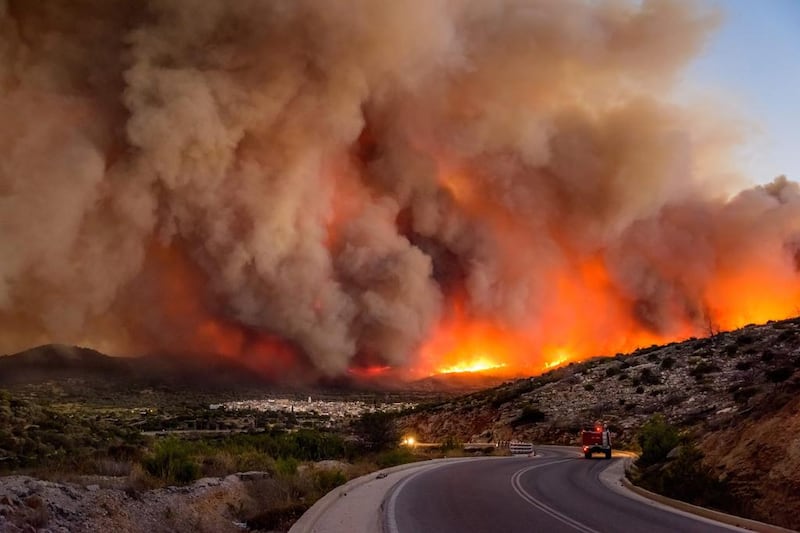 Smoke over Lithi village during a wildfire on Chios island, Greece. Kostas Koyrgias / EPA