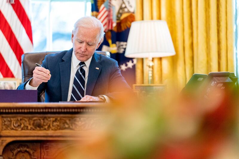 President Joe Biden signs the American Rescue Plan, a coronavirus relief package, in the Oval Office of the White House, Thursday, March 11, 2021, in Washington. (AP Photo/Andrew Harnik)