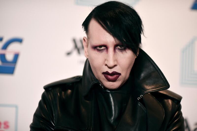 FILE - Marilyn Manson attends the 9th annual "Home for the Holidays" benefit concert on Dec. 10, 2019, in Los Angeles. Manson was dropped by his record label Monday after his ex-fiancÃ©, the actor Evan Rachel Wood, accused him of sexual and other physical abuse. (Photo by Richard Shotwell/Invision/AP, File)