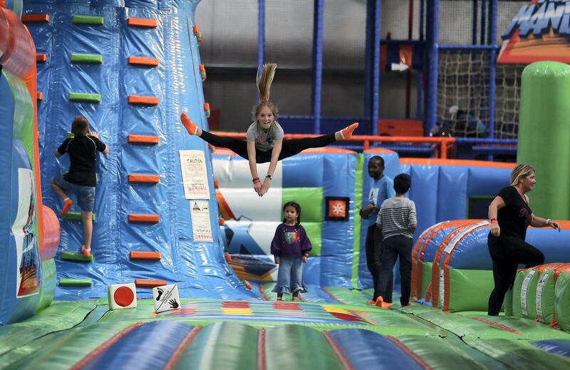 DUBAI , UNITED ARAB EMIRATES , January 15 – 2019 :- Harriet Osgerby (center jumping) enjoying at the Air Maniax, a brand new indoor adventure park of 23,000 sq ft, with activities for all ages which opened in Al Quoz Industrial area in Dubai. (Pawan Singh / The National ) For Arts & Life. Story by Hala Khalaf