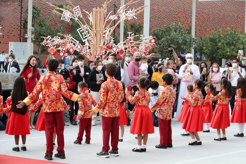 A group of pupils sing songs outside the Chinese pavilion.  Pawan Singh / The National