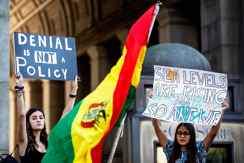 Protesters hold signs during the Global Climate Strike demonstration in New York, U.S., on Friday, Sept. 20, 2019. Protesters took to streets, parks and plazas around the world on Friday in a day of action demanding more aggressive steps against global warming. Photographer: Demetrius Freeman/Bloomberg