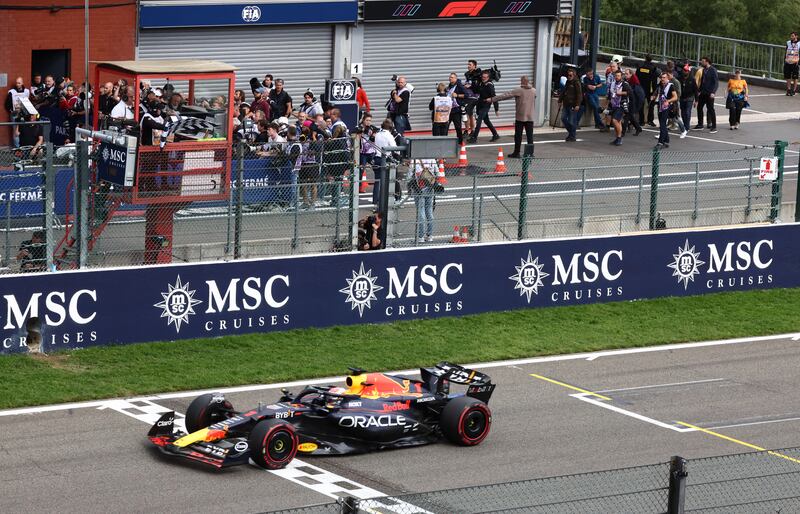 Red Bull's Max Verstappen takes the chequered flag to win the Belgian GP. Reuters