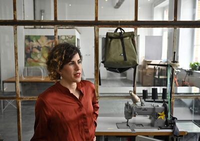 Vera Guenther, co-founder of the small Berlin-based company "Mimycri", answers AFP journalists' questions on July 12, 2019 at Mimycri's workshop in Berlin, where the material, from rubber dinghies initially abandoned by migrants on beaches of Greek islands, finds a second life. Mimycri recovers inflatable boats, abandoned on the shores of Chios and the near-by island of Lesbos, which both bore witness to the 2015 refugee crisis when hundreds of thousands of refugees landed on Europe's beaches. The fabric from rubber dinghies is transformed by refugees into different sorts of bags, sold on the internet. / AFP / Tobias SCHWARZ
