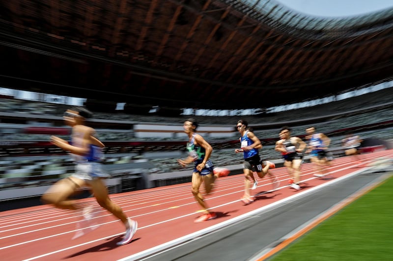Japan's Kazuto IIzawa (11) competes with other runners during the men's 1500m final at the morning session of the athletics test event. Reuters