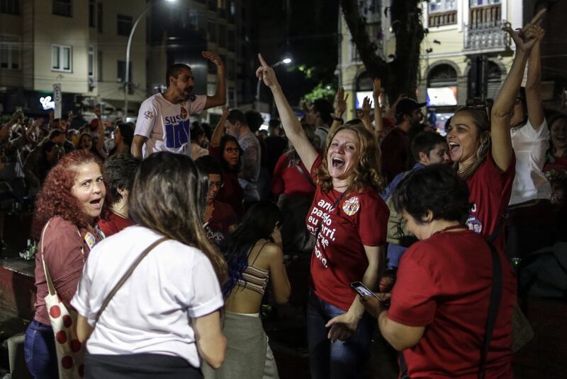 Lula supporters in jubilant mood in Rio de Janeiro. However, the election will go to a run-off as the leftist candidate fell short of 50 per cent of the vote. EPA