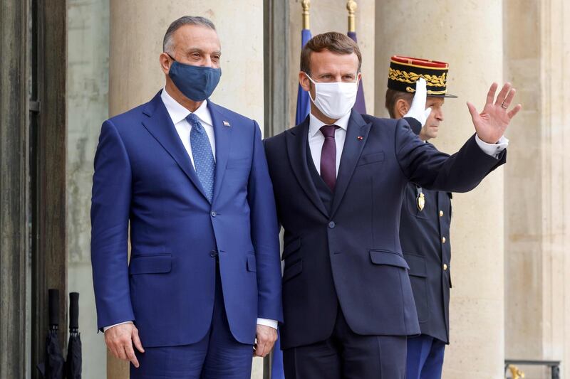 Prime Minister of Iraq Mustafa al-Kadhimi is welcomed by France's President Emmanuel Macron ahead of a working lunch at the Elysee Palace in Paris.  AFP