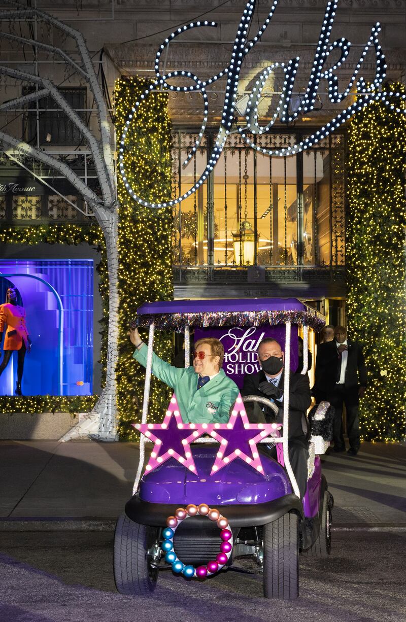 Sir Elton John makes his entry at Saks on a golf cart featuring his signature star glasses. Photo: Michael Blanchard