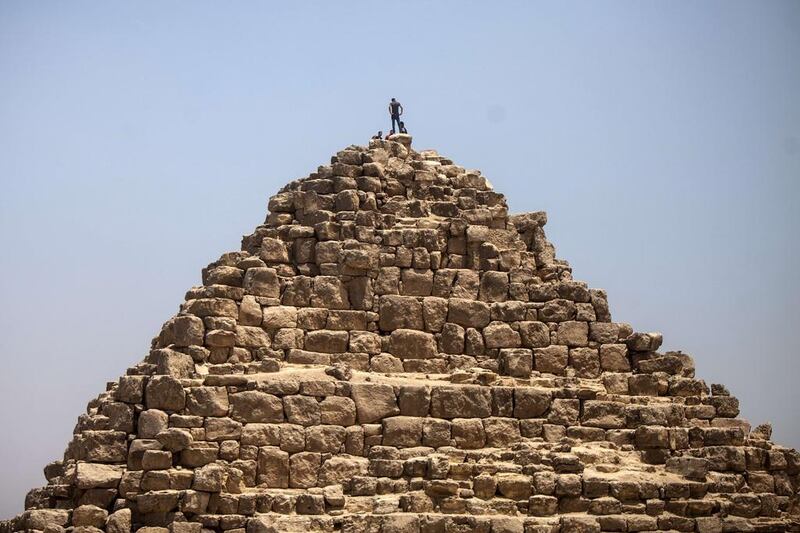 An Egyptian man is seen at the top of one of the Gaza pyramids, south of Cairo. Mahmoud Khaled / AFP 