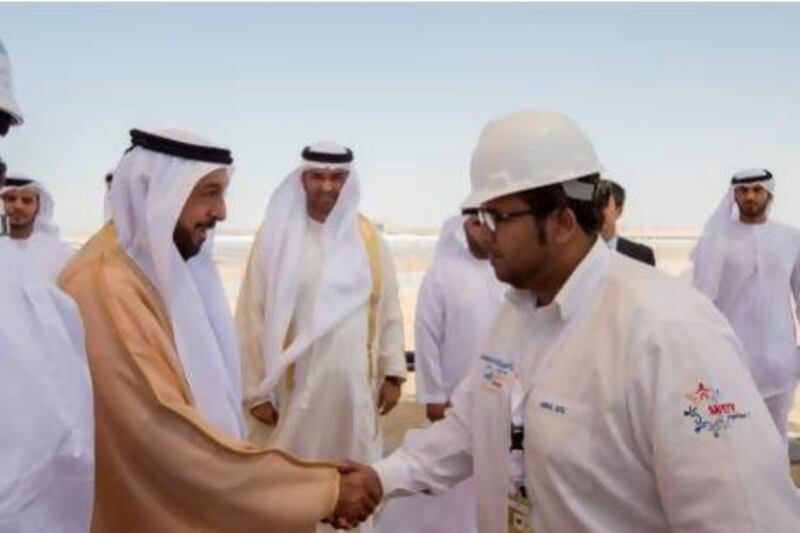 Sheikh Khalifa bin Zayed Al Nahyan President of the UAE and Ruler of Abu Dhabi (L), greets Shams Power Company employees during the Shams 1 opening ceremony. Ryan Carter / Crown Prince Court - Abu Dhabi