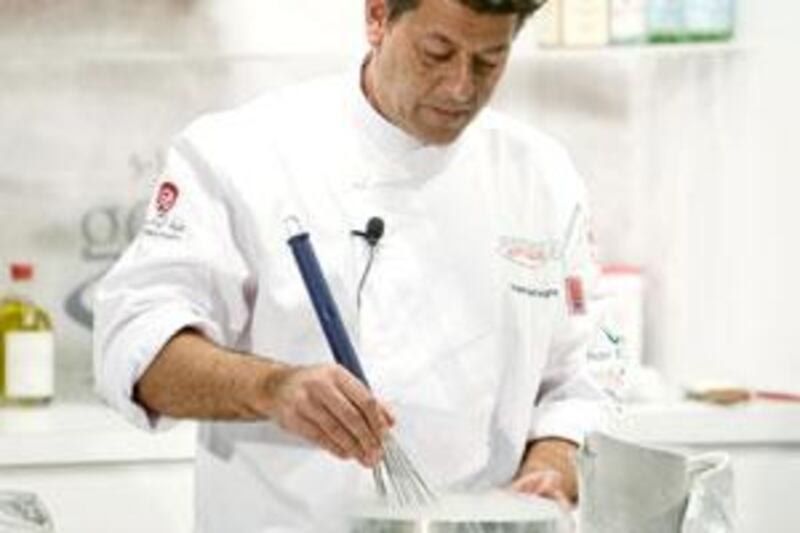The chef Yves Mattagne stirs liquid nitrogen.