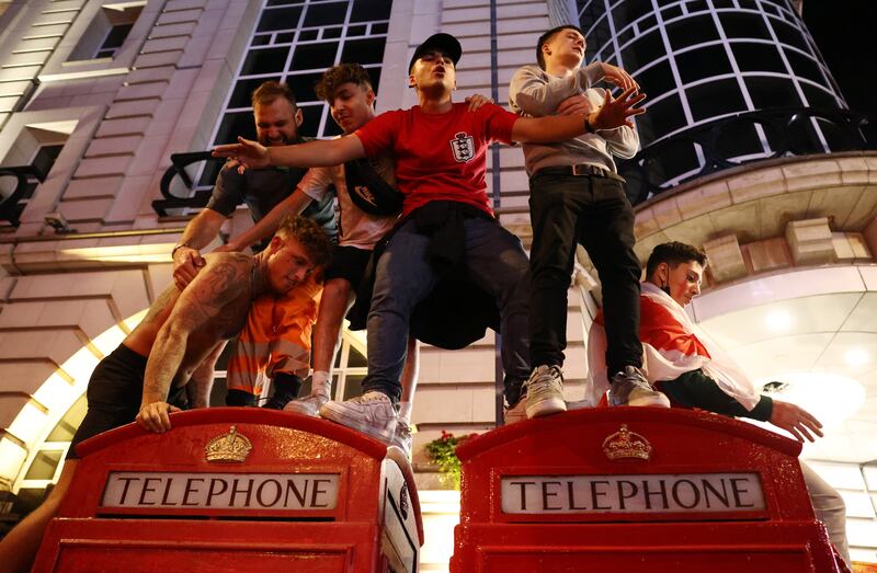 England fans celebrate on the streets of Piccadilly Circus.