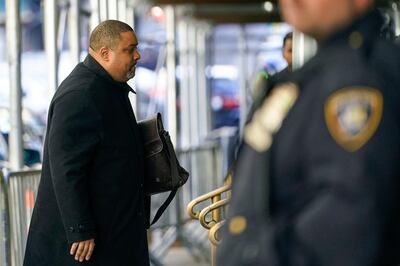 A court officer stands guard as Manhattan District Attorney Alvin Bragg arrives at his office in New York. AP