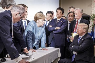 CHARLEVOIX, CANADA - JUNE 9:   In this photo provided by the German Government Press Office (BPA), German Chancellor Angela Merkel deliberates with US president Donald Trump on the sidelines of the official agenda on the second day of the G7 summit on June 9, 2018 in Charlevoix, Canada. Also pictured are (L-R) Larry Kudlow, director of the US National Economic Council, Theresa May, UK prime minister, Emmanuel Macron, French president, Angela Merkel, Yasutoshi Nishimura, Japanese deputy chief cabinet secretary, Shinzo Abe, Japan prime minister, Kazuyuki Yamazaki, Japanese senior deputy minister for foreign affairs, John Bolton, US national security adviser, and Donald Trump. Canada are hosting the leaders of the UK, Italy, the US, France, Germany and Japan for the two day summit. (Photo by Jesco Denzel /Bundesregierung via Getty Images)