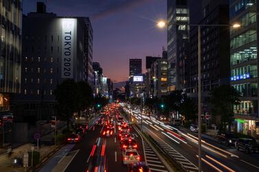 Cars pass through a business district in Tokyo. Japan aims to eliminate petrol-powered vehicles in about 15 years in a plan to achieve Prime Minister Yoshihide Suga’s ambitious pledge to go carbon-free by 2050. Photo: AP