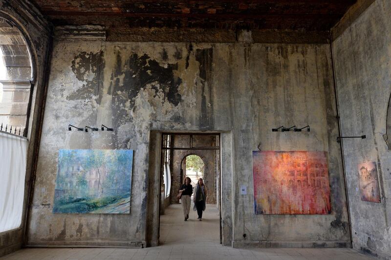 Visitors viewing paintings by 45-year-old British artist Tom Young during an exhibition at the Sawfar Grand Hotel in the village of Sawfar southeast Beirut, Lebanon. EPA
