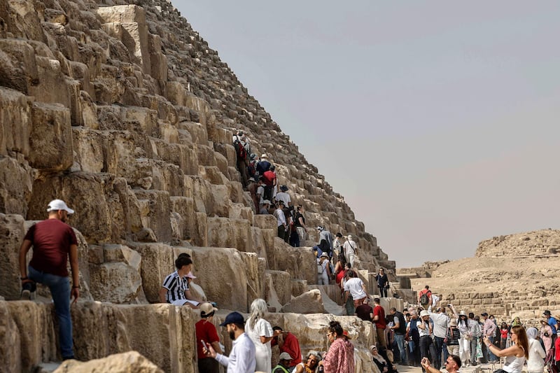 Tourists surround the Great Pyramid of Khufu (Cheops) at the Giza Pyramids necropolis. AFP