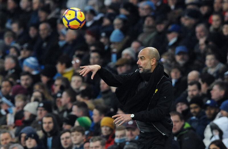 Manchester City coach Pep Guardiola throws the ball back into play during the English Premier League soccer match between Manchester City and Newcastle United at the Etihad Stadium in Manchester, England, Saturday, Jan. 20, 2018. (AP Photo/Rui Vieira)