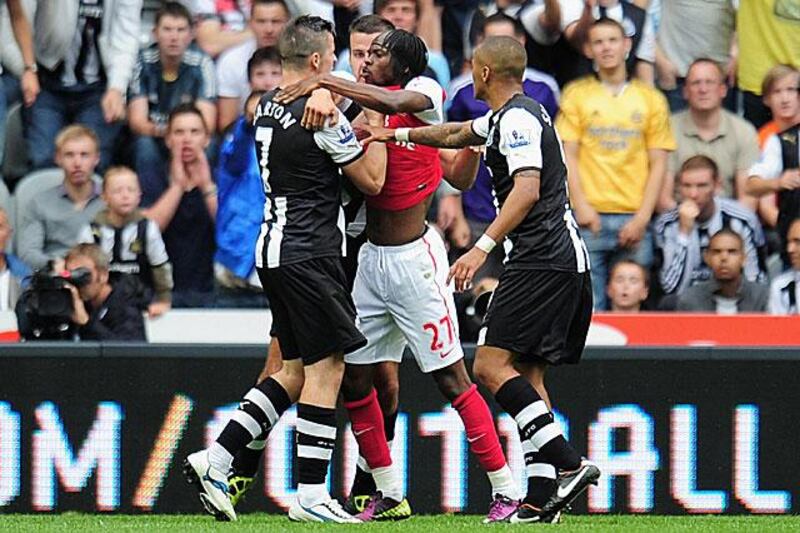 Gervinho of Arsenal, right, confronts Newcastle midfielder Joey Barton shortly before being shown the red card by referee Peter Walton during a 0-0 draw at St James' Park.