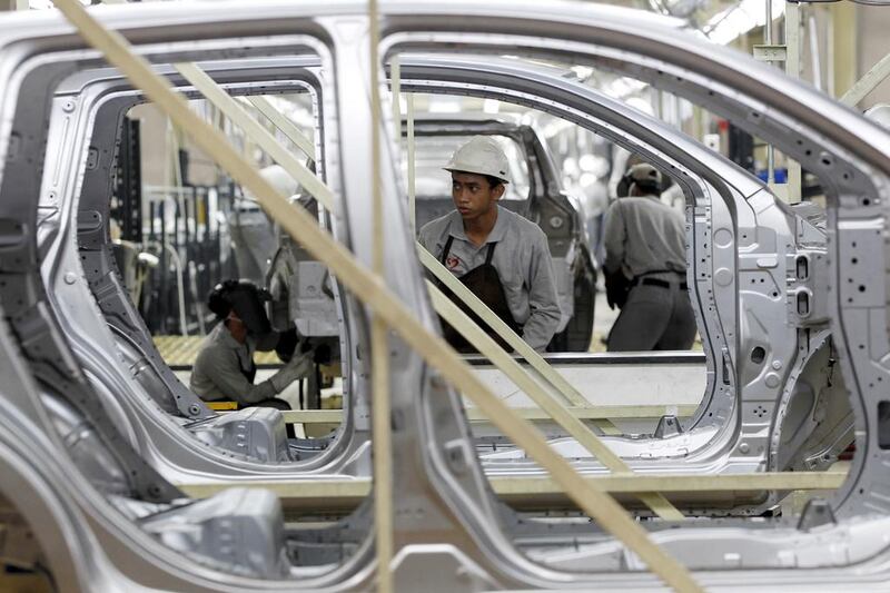 A worker inspects a body of Datsun Go+ at an assembly line in the Nissan Indonesia factory. Beawiharta / Reuters