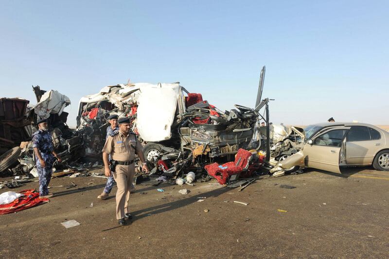 Omani police inspect the site of a collision between a lorry and a bus in western Oman in 2016 in which 18 people were killed. AFP

