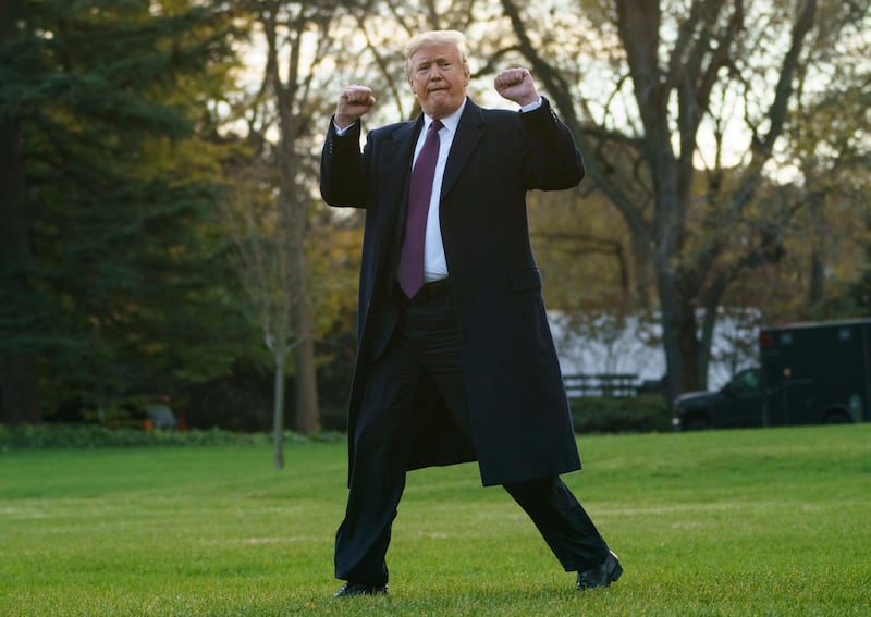FILE - In this Nov. 20, 2018, file photo, President Donald Trump gestures as he walks to Marine One after speaking to media at the White House in Washington. (AP Photo/Carolyn Kaster, File)