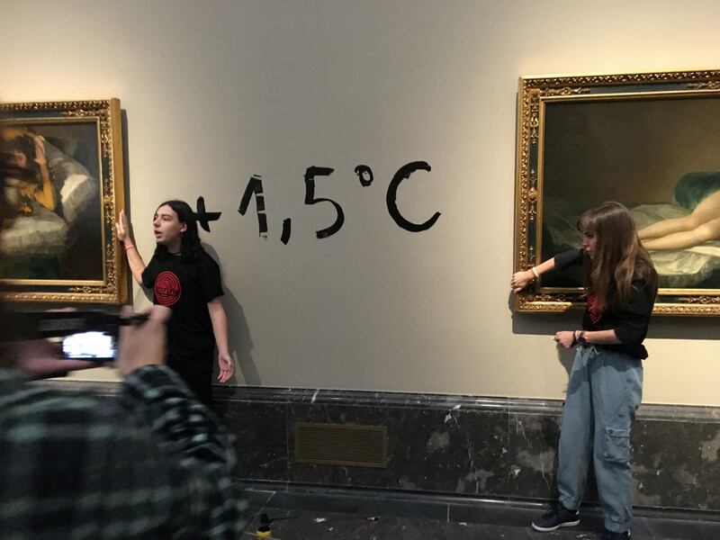 Climate protesters from Extinction Rebellion stick themselves to the frames of Goya paintings. Reuters