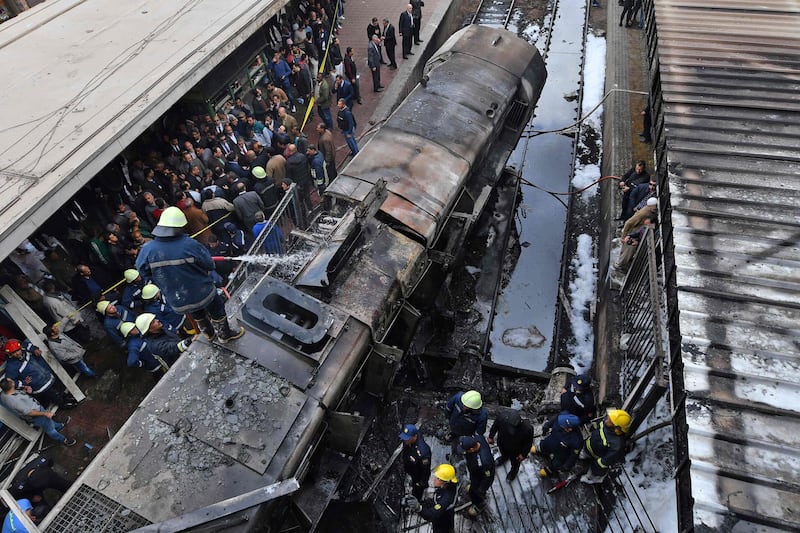 Fire fighters and onlookers gather at the scene of a fiery train crash at the Egyptian capital Cairo's main railway station on February 27, 2019.  The crash killed at least 20 people, Egyptian security and medical sources said.
The accident, which sparked a major blaze at the Ramses station, also injured 40 others, the sources said.
 / AFP / STRINGER
