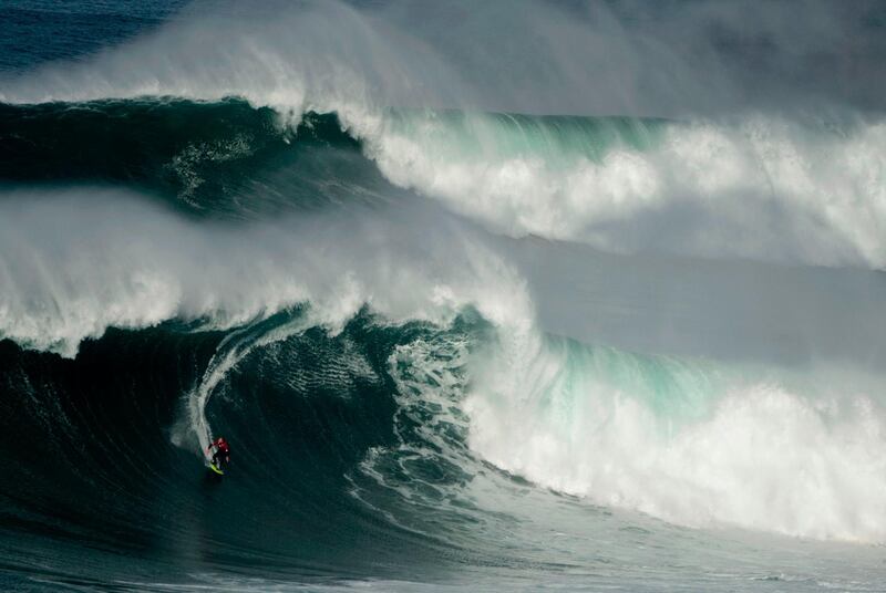 A surfer rides a big wave at the Praia do Norte in Nazare, on February 15. AFP