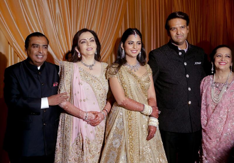 From left, Reliance Industries Chairman Mukesh Ambani, his wife Nita Ambani, his daughter Isha, groom Anand Piramal, and his mother Swati Piramal. Photo: AP