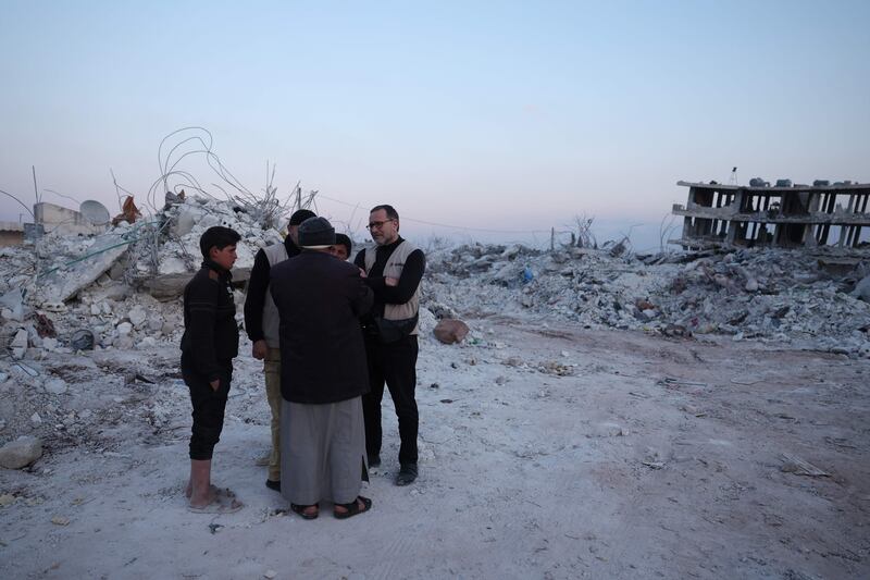 Raphael Pitti (R), a doctor with the French NGO Mehad, tours devastated areas in Jindayris. AFP