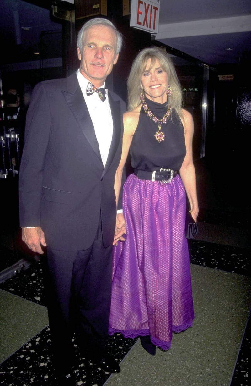 Jane Fonda, in a black racer top and purple skirt, with Ted Turner on March 5, 1999