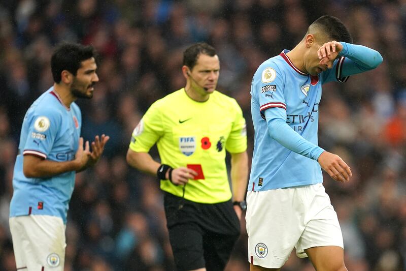 Referee Darren England shows a red card to  Joao Cancelo. PA