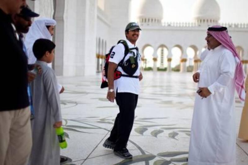 Surrounded by close friends and family, Fadhel Mohammed Rasool Khoori, a 33-year-old Emirati, starts a two-week-long walkabout on Thursday afternoon, June 2, 2011, at the Sheikh Zayed Grand Mosque in Abu Dhabi. Khoori is embarking on a walk around the seven Emirates to show his gratitude to Sheikh Khalifa and the rulers for everything they have done for Emiratis.(Silvia Razgova / The National)



