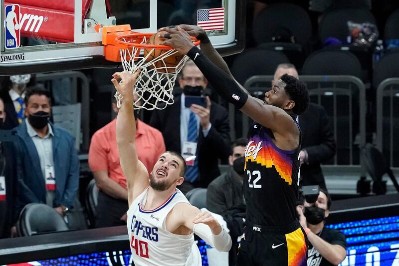 Phoenix Suns center Deandre Ayton, right, scores over Los Angeles Clippers center Ivica Zubac during the second half of Game 2 of the NBA basketball Western Conference Finals, Tuesday, June 22, 2021, in Phoenix. (AP Photo/Matt York)
