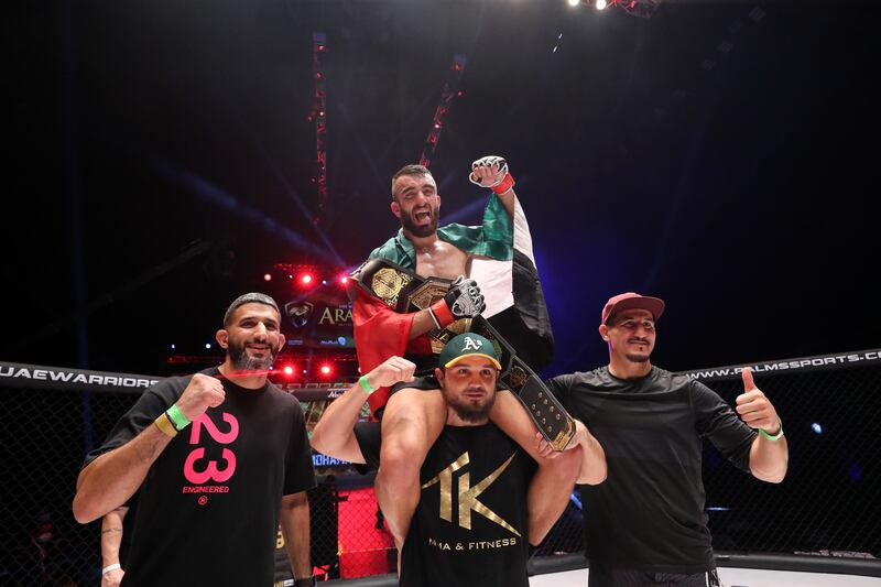 Mohammad Yahya celebrates with his team after defending his UAE Warriors Arabia Lightweight title against Mohamed El Jaghdal. Chris Whiteoak / The National