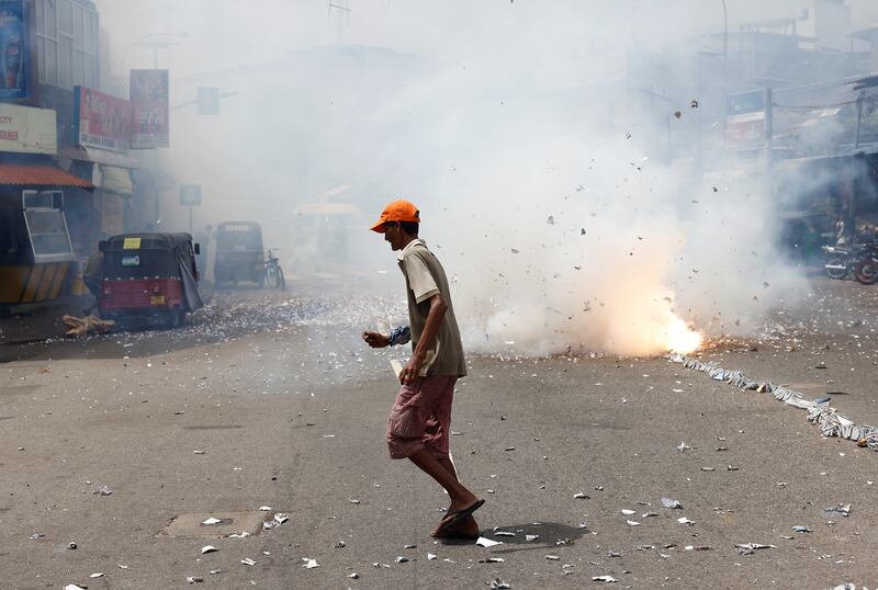 A supporter celebrates in Colombo after Mr Wickremesinghe was elected as president. Reuters