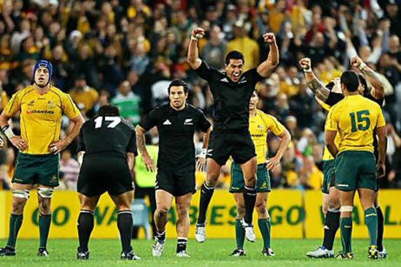 Mils Muliaina, centre, of the All Blacks celebrates after defeating Australia in the final Tri Nations match on Saturday.