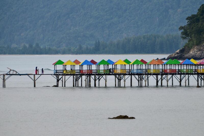 People walk on a platform at a beach in Lhokseudu near Banda Aceh.   AFP