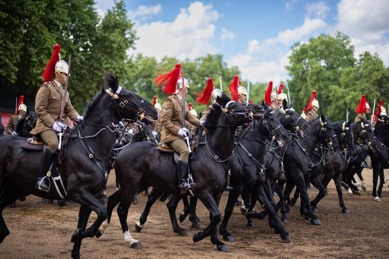 Members of the British Armed Forces participate in The Brigade Major's Review on Thursday, the last rehearsal of Trooping the Colour before it is performed in public, in London. EPA